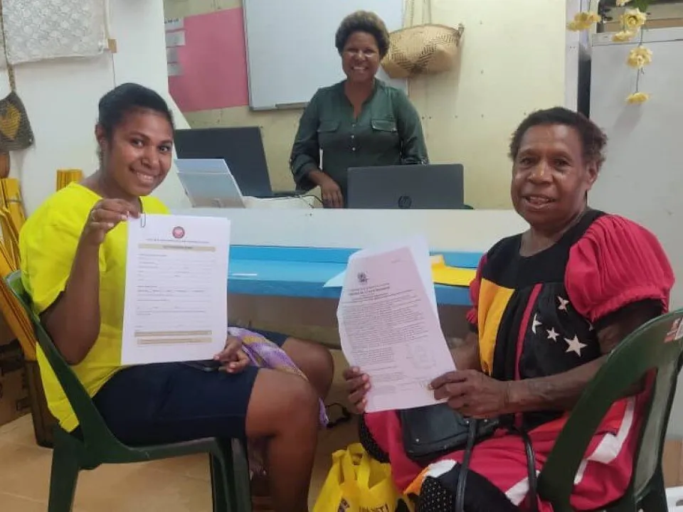 Glenda-Supring-Glenda-center-serving-her-first-passport-visa-service-customers