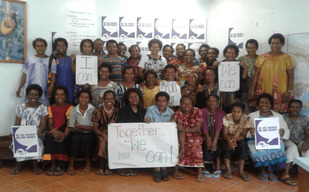 Volunteers pose with signs to end GSV at Eastern Highlands Family Voice