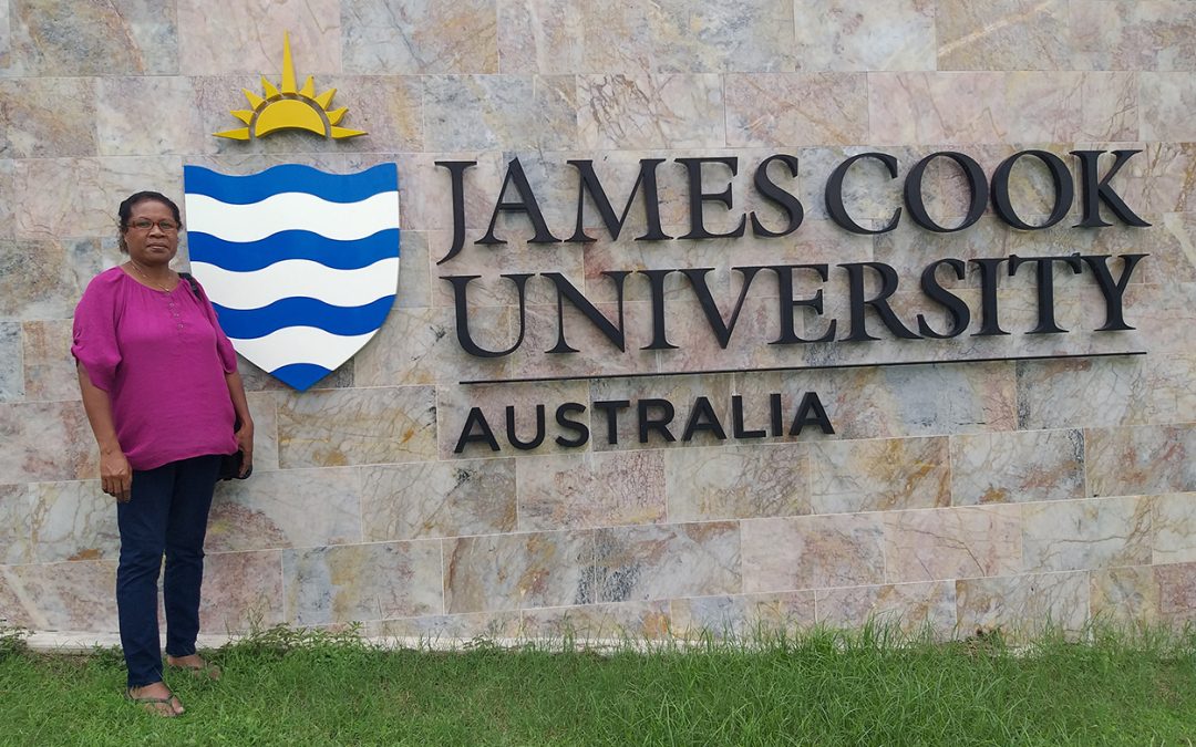 Photo of Petra next to the James Cook University sign board